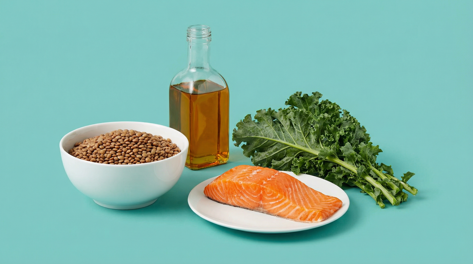 MASLD diet foods including leafy greens, olive oil, salmon, and legumes on a teal background