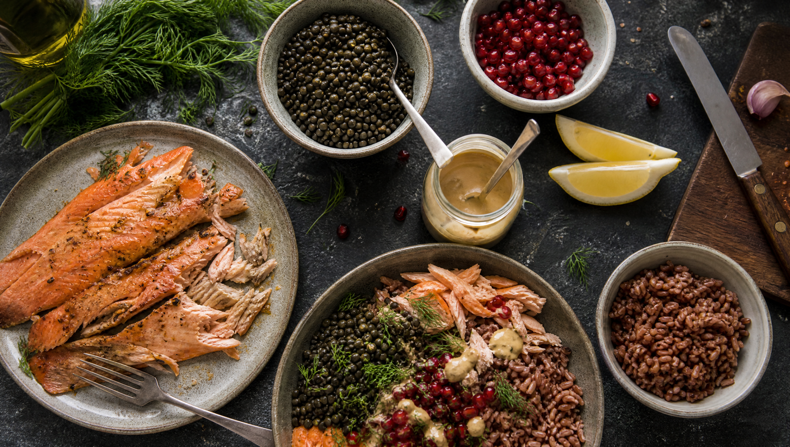 healthy fats vs sugar — meal prep overhead with smoked trout, lentils, pomegranate and tahini on slate