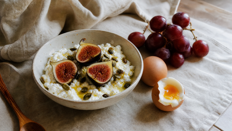cottage cheese bowl with figs, pumpkin seeds and soft-boiled eggs on linen cloth — metabolic-friendly snacks