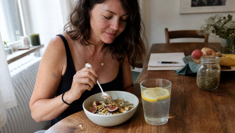 managing prediabetes naturally — woman reviewing healthy meal plan at kitchen table