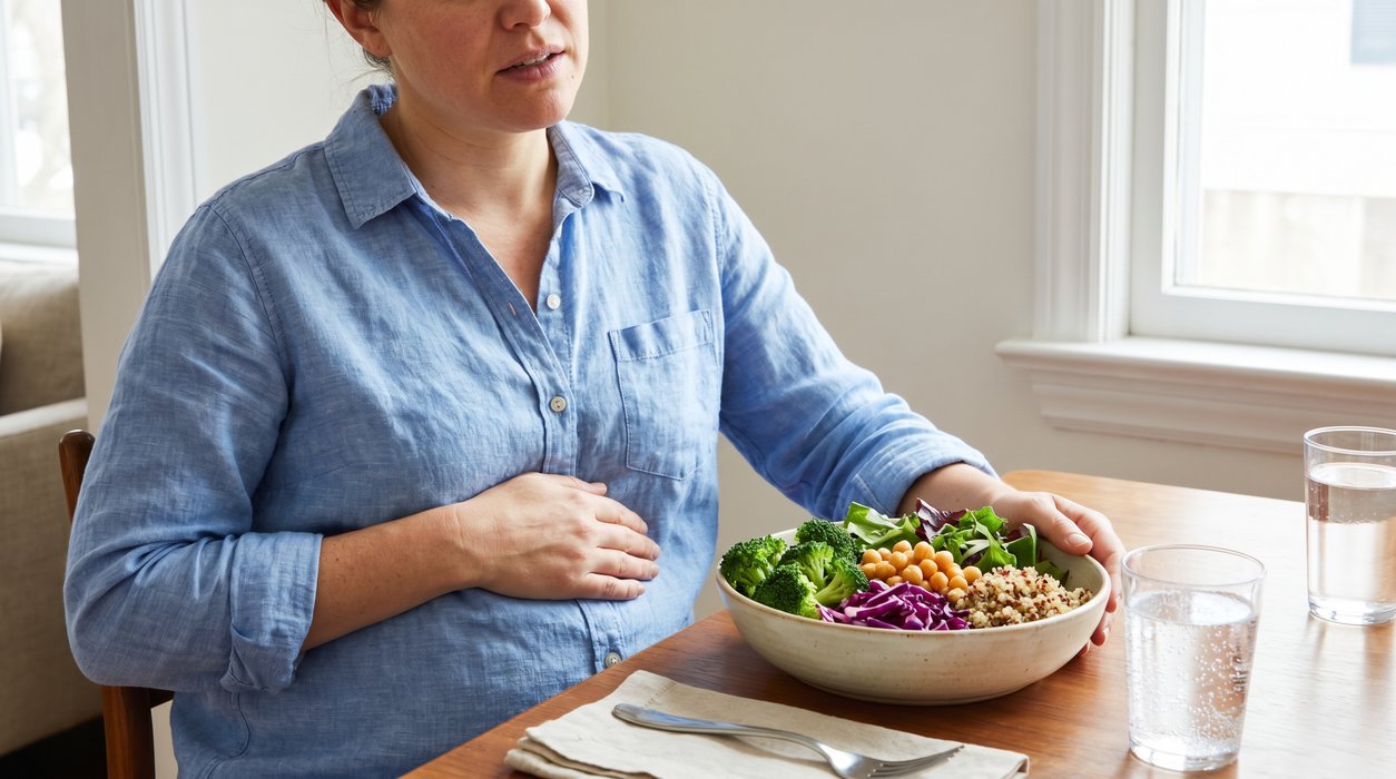 woman feeling bloated after a large high fiber salad