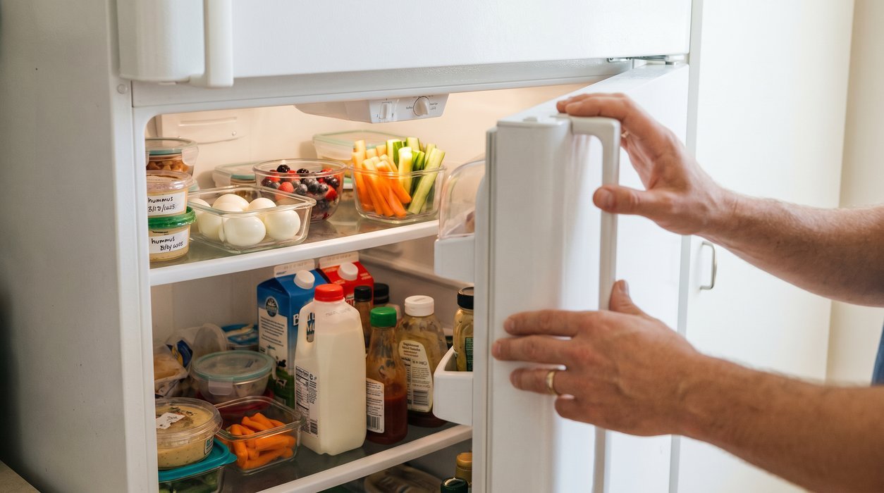 Open fridge shelf with ready protein, fruit, and vegetables for easier snack choices