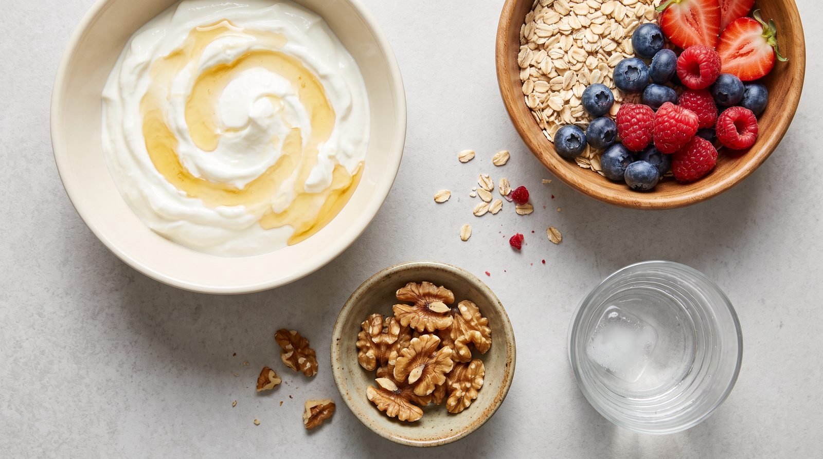 Perimenopause breakfast formula with Greek yogurt, oats and berries, walnuts, and water arranged as four practical components